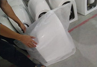 Worker wrapping ceramic product in protective film